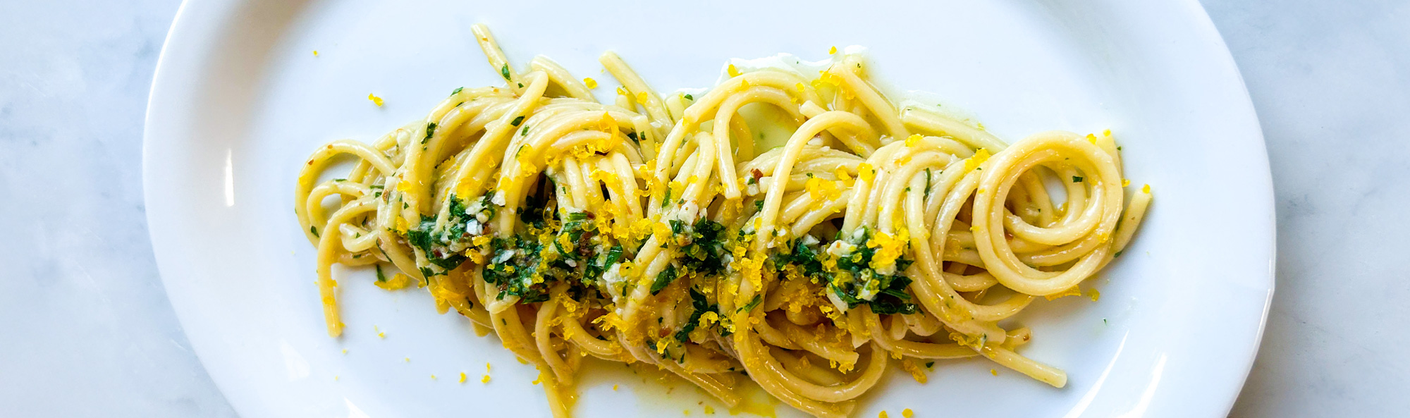 Spaghetti aglio e olio with cured egg yolks